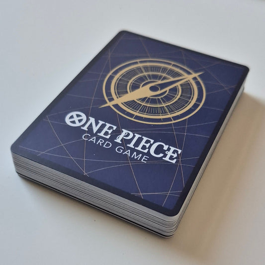 One Piece kaarten set Japans - 30 kaarten + 1 holo met stijlvolle achterkant en kompasdesign. Perfect voor verzamelaars en fans van OP-07.